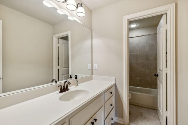 full bathroom featuring tile patterned flooring, vanity, toilet, and tiled shower / bath