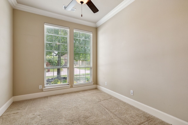 spare room with carpet, ceiling fan, and crown molding