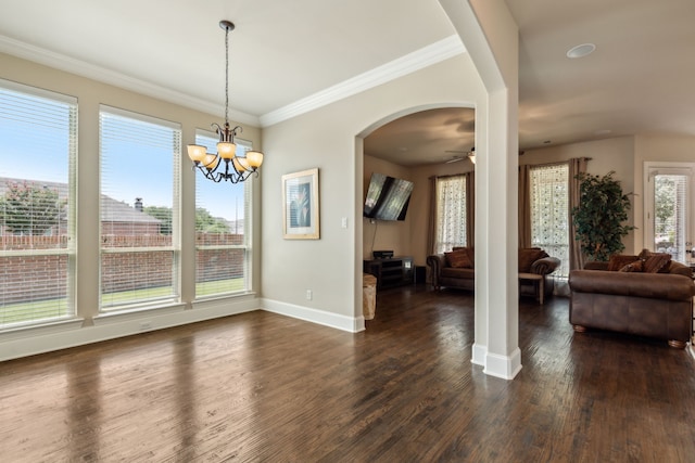 dining space featuring ceiling fan with notable chandelier, crown molding, and dark wood-type flooring