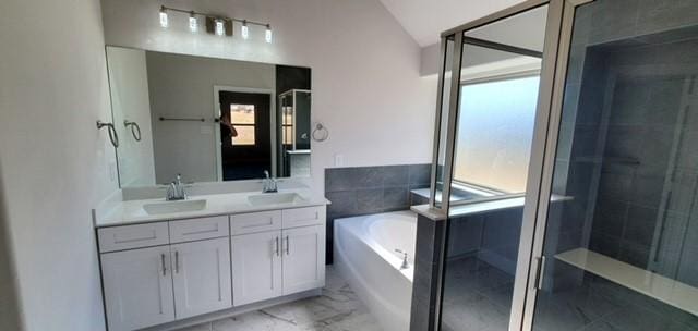 bathroom featuring vanity, shower with separate bathtub, and lofted ceiling