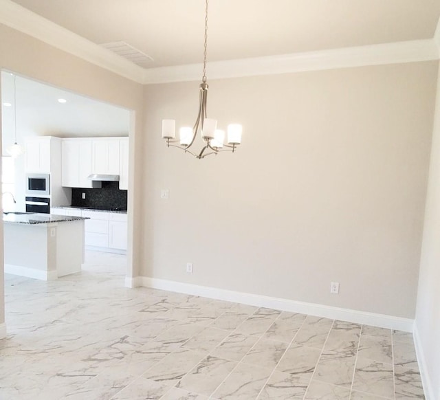 unfurnished dining area with a notable chandelier, ornamental molding, and sink