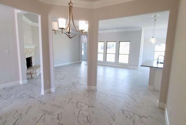 unfurnished dining area with a notable chandelier, a healthy amount of sunlight, ornamental molding, and a fireplace