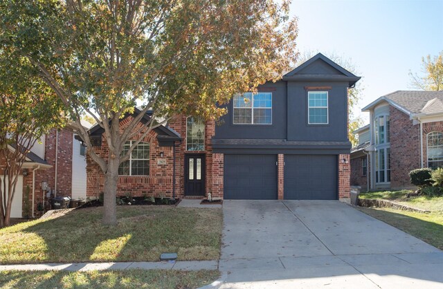 front facade featuring a garage and a front lawn