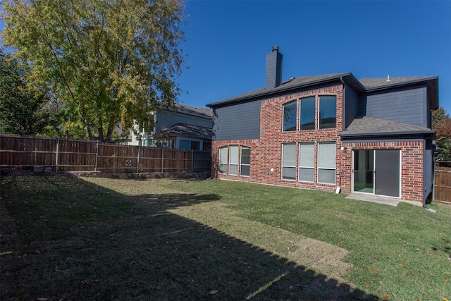 rear view of house with a lawn