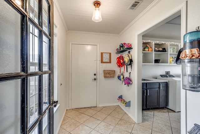 interior space with ornamental molding and washer / clothes dryer