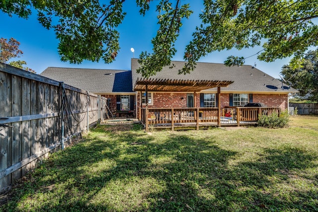 rear view of house with a yard, a pergola, and a deck