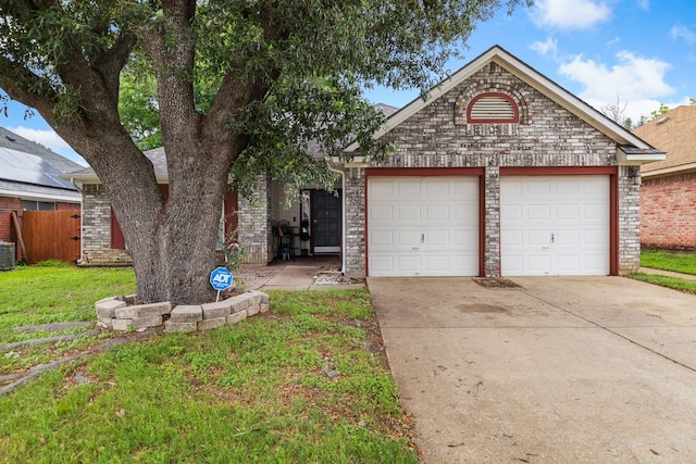 view of front of home featuring central AC, a front lawn, and a garage