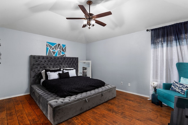 bedroom featuring dark hardwood / wood-style floors, vaulted ceiling, and ceiling fan