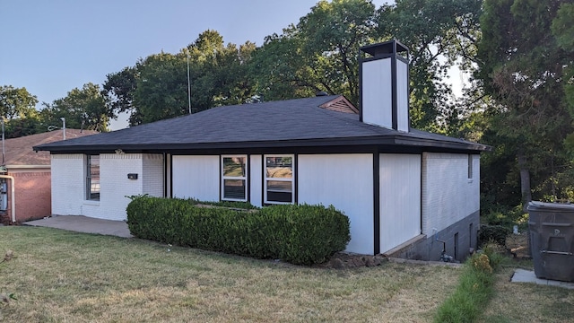 rear view of property featuring a yard