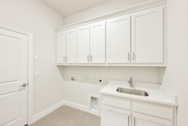 washroom with hookup for a washing machine, cabinet space, a sink, electric dryer hookup, and baseboards