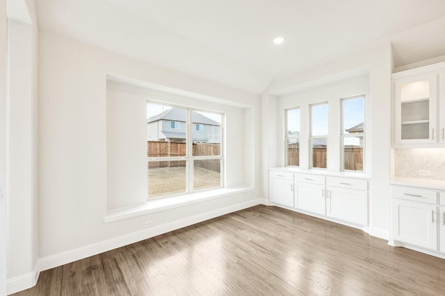 interior space featuring light wood-style flooring, baseboards, and recessed lighting