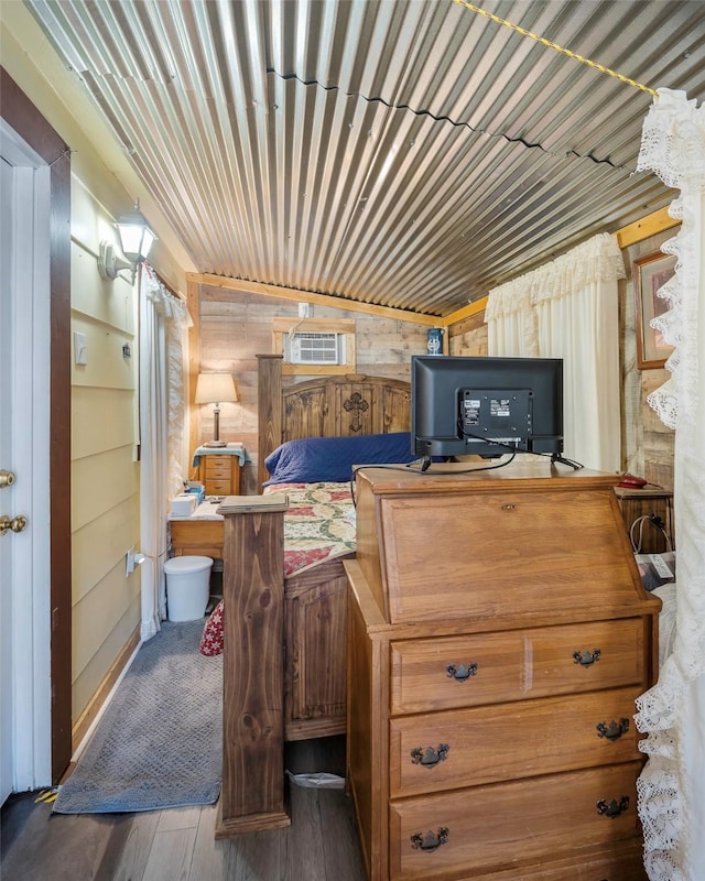 bedroom featuring wood walls and dark wood-type flooring