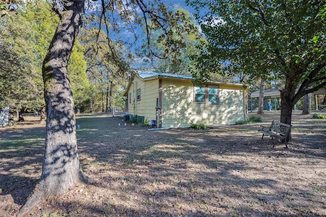 view of side of home with central air condition unit