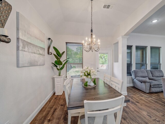 dining room featuring crown molding, dark hardwood / wood-style flooring, and a notable chandelier