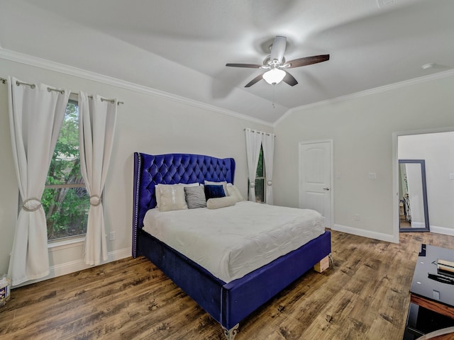 bedroom with crown molding, wood-type flooring, and vaulted ceiling