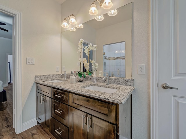 bathroom featuring vanity, hardwood / wood-style floors, crown molding, and an enclosed shower