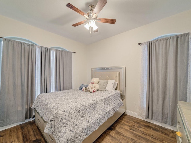 bedroom with ceiling fan and dark hardwood / wood-style floors