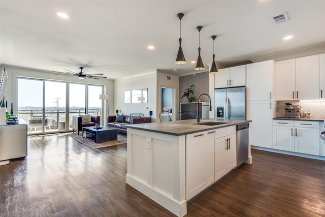 kitchen featuring a kitchen island with sink, white cabinets, stainless steel appliances, and dark hardwood / wood-style floors