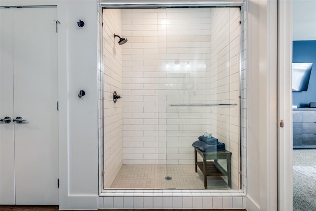 bathroom featuring a shower with door