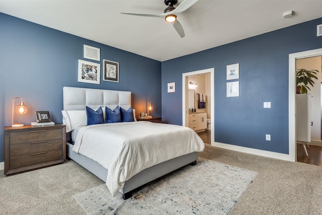 bedroom featuring carpet, ensuite bath, and ceiling fan