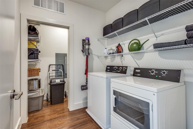 clothes washing area with dark hardwood / wood-style flooring and washing machine and dryer