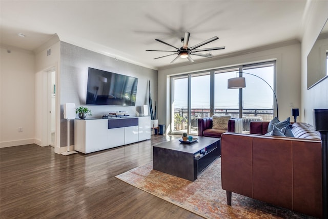 living room featuring dark hardwood / wood-style flooring, ceiling fan, and ornamental molding