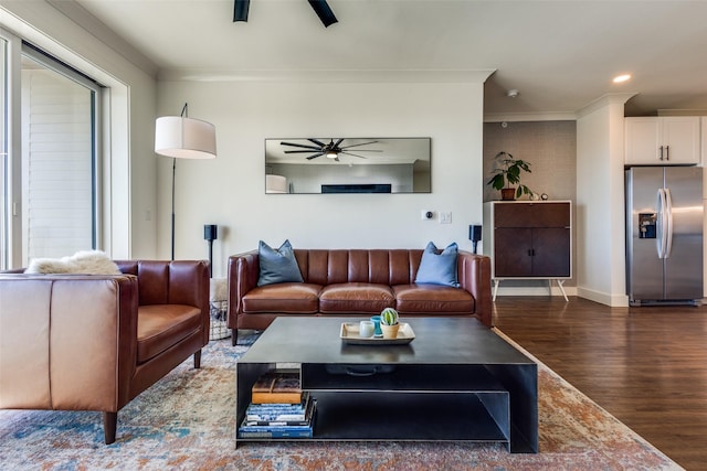 living room with ceiling fan, dark hardwood / wood-style floors, and ornamental molding