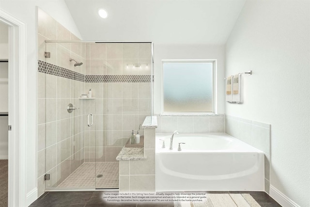 bathroom featuring vaulted ceiling and independent shower and bath