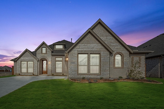 french country style house featuring a lawn