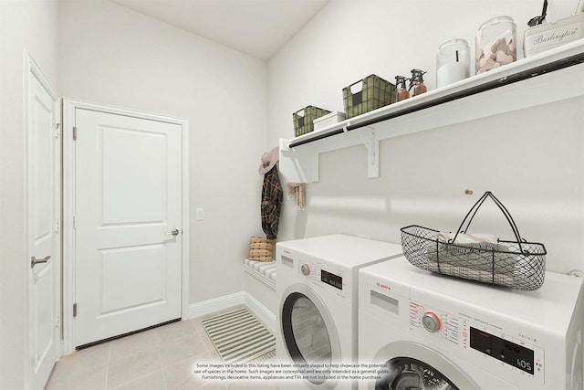 laundry room with light tile patterned flooring and washing machine and clothes dryer