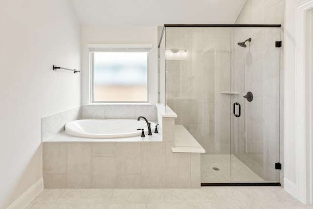 bathroom with tile patterned floors and plus walk in shower