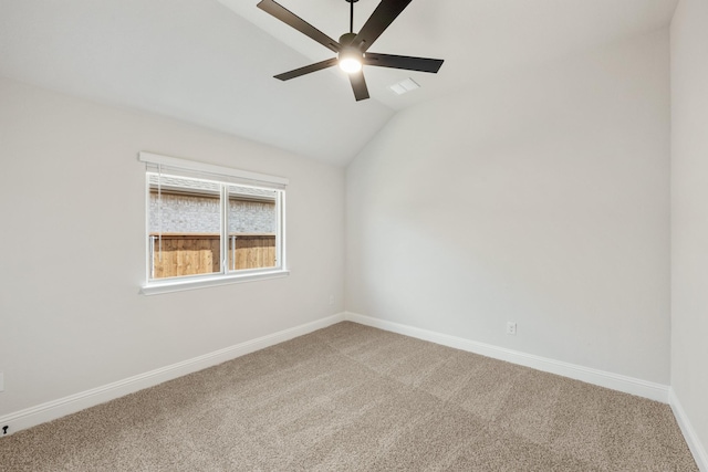 spare room with carpet, vaulted ceiling, and ceiling fan