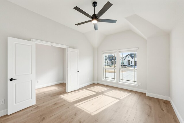 living room featuring built in shelves, ceiling fan, and wood-type flooring