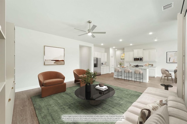 living room with hardwood / wood-style flooring and ceiling fan