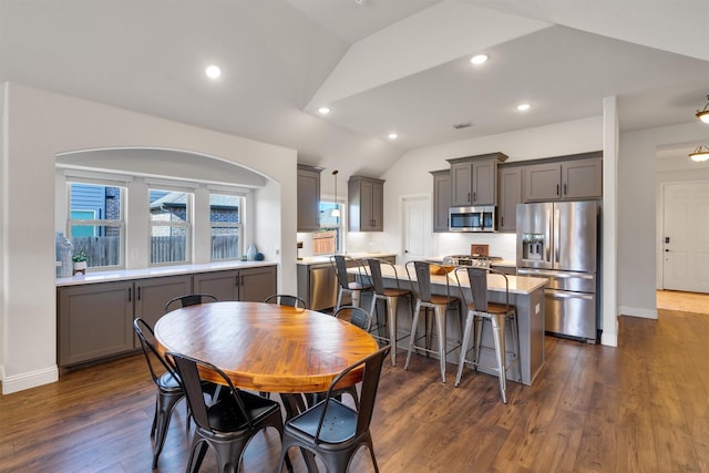 dining space featuring dark hardwood / wood-style flooring and lofted ceiling