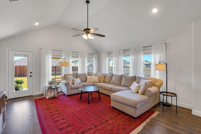 living room with dark hardwood / wood-style flooring, high vaulted ceiling, ceiling fan, and a healthy amount of sunlight