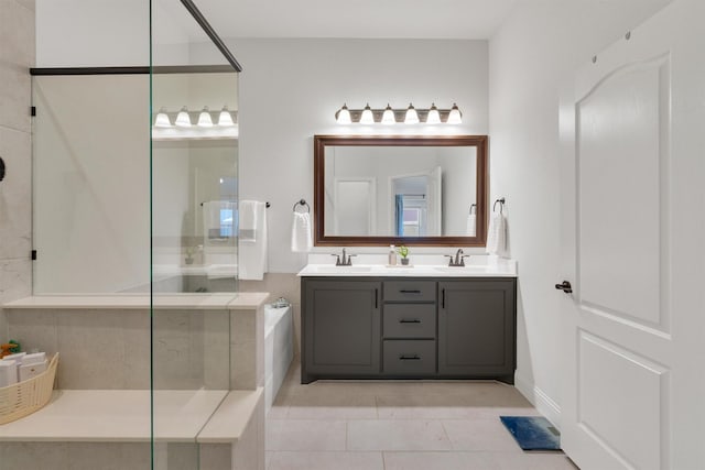 bathroom with a shower, vanity, and tile patterned floors