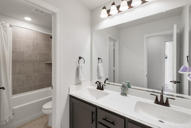 full bathroom with vanity, shower / tub combo, and toilet