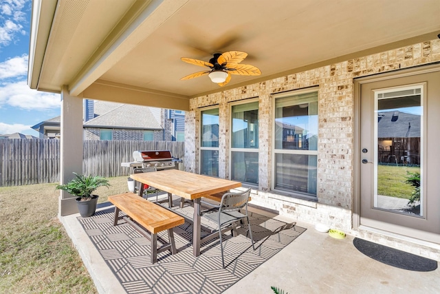 view of patio with ceiling fan and a grill