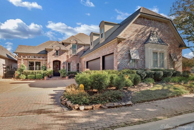 french provincial home with a garage