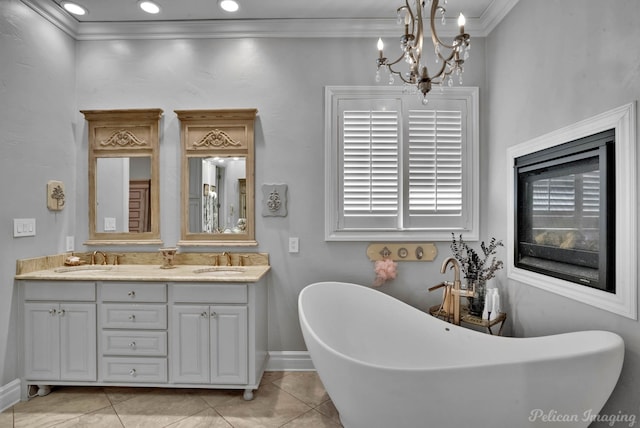 bathroom with ornamental molding, a tub to relax in, tile patterned flooring, and vanity