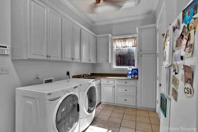 laundry area with washer and dryer, sink, cabinets, ornamental molding, and light tile patterned floors