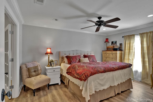 bedroom with ornamental molding, ceiling fan, and light wood-type flooring