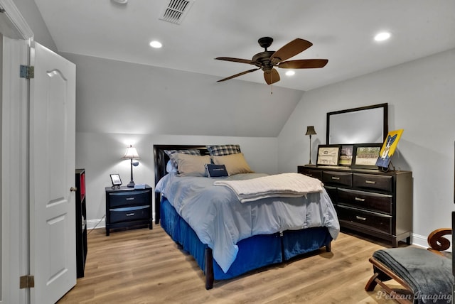 bedroom with ceiling fan, vaulted ceiling, and light hardwood / wood-style flooring