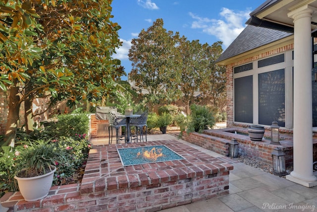 view of patio with a fire pit