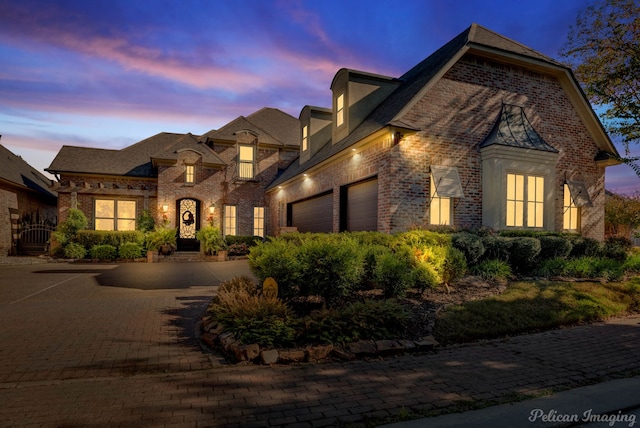 french provincial home featuring a garage