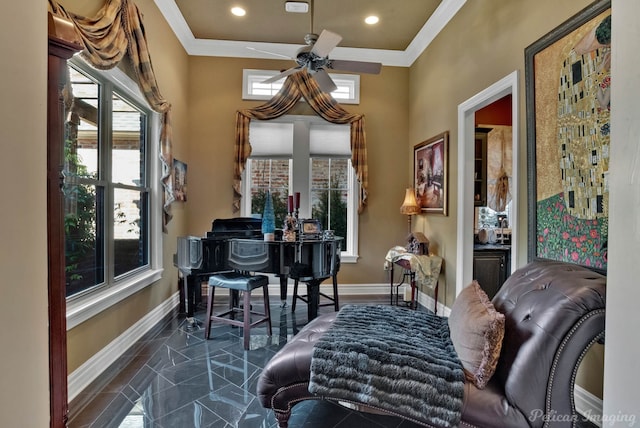 living area with crown molding and ceiling fan