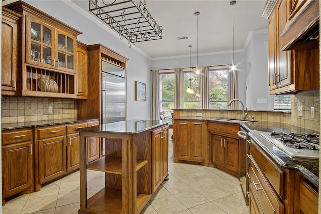 kitchen featuring sink, tasteful backsplash, crown molding, pendant lighting, and light tile patterned floors