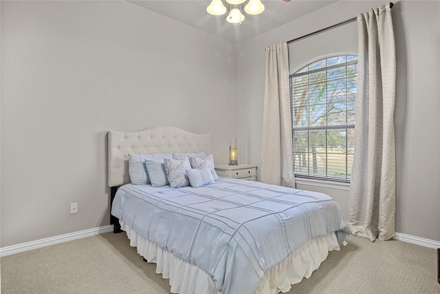 bedroom with ceiling fan and light colored carpet