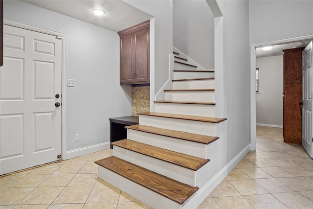 stairs with tile patterned floors